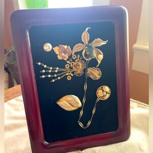 I make art out of old vintage jewelry. This is a 5x7 picture.